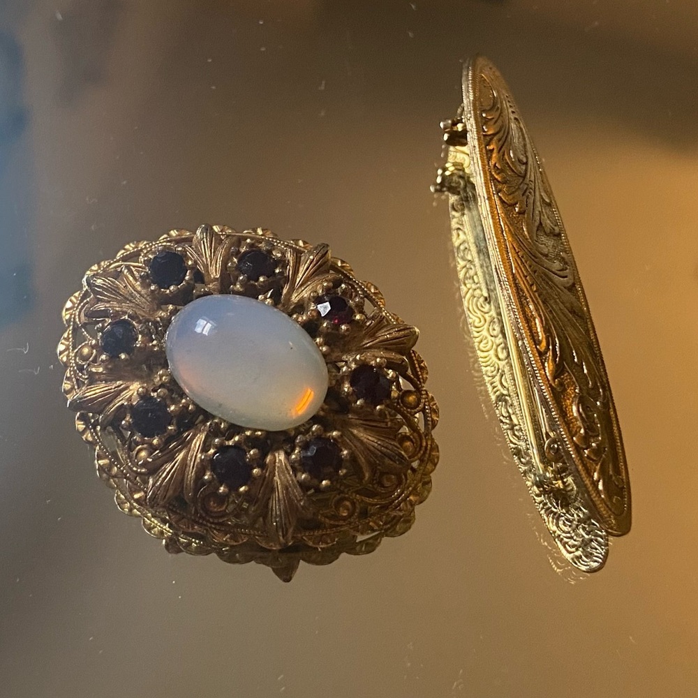 Two gold plated pins with stone like jewels